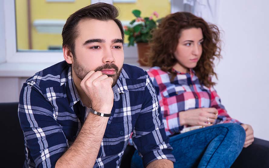 woman being bored watching tv with boyfriend